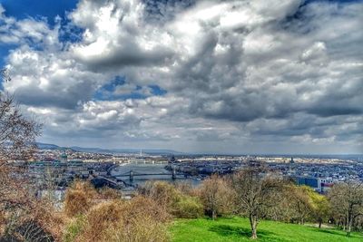 View of cityscape against cloudy sky