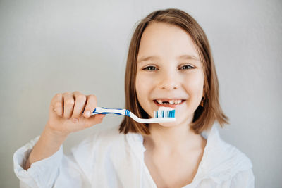 Girl brushes her teeth, dental care since childhood, a visit to the dentist