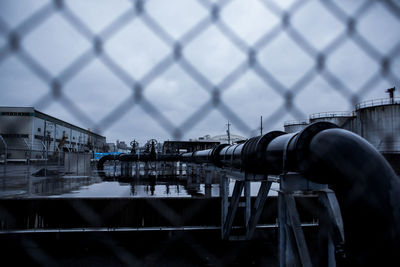 Factory seen through chainlink fence