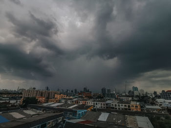 High angle view of city against dramatic sky