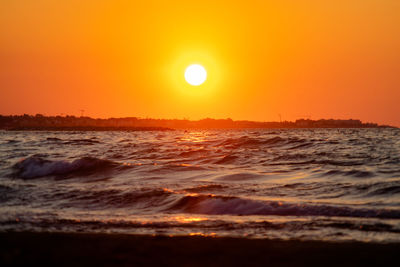 Scenic view of sea against romantic sky at sunset