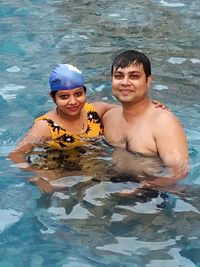 Portrait of a smiling man swimming in pool