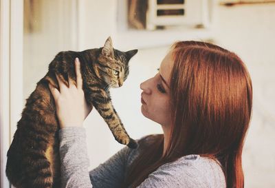 Young woman sitting cat