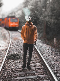 Full length of man standing on railroad track
