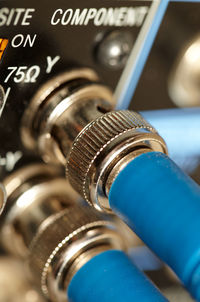 Extreme close-up of blue cables connected to amplifier