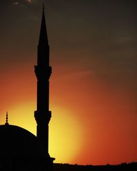 Low angle view of silhouette building against sky during sunset