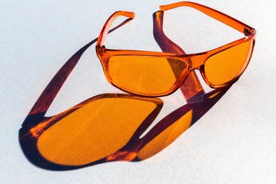 Close-up of sunglasses on glass against white background