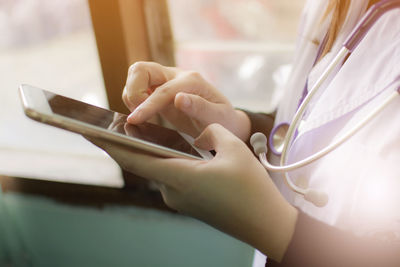 Midsection of man using mobile phone