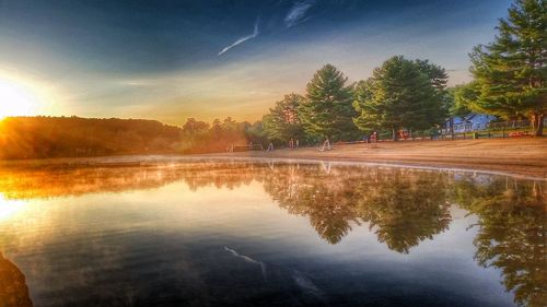 Scenic view of lake against sky at sunset