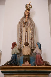 Low angle view of statue against temple