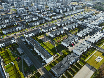 Aerial photo of the modern residential district in growing europe city. block flats and cottages.