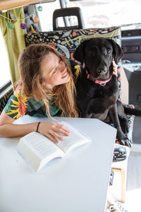 Woman traveling with dog in camper van