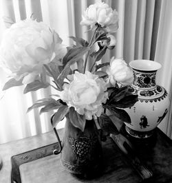 Close-up of flower vase on table at home