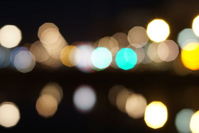 Defocused image of illuminated lights in city at night
