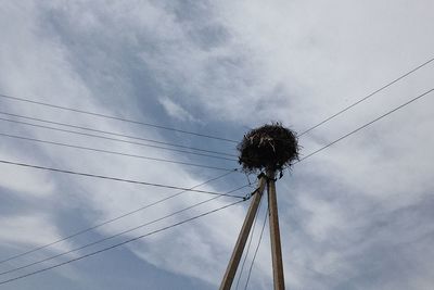 Low angle view of electricity pylon against sky