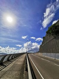 Road by street against sky