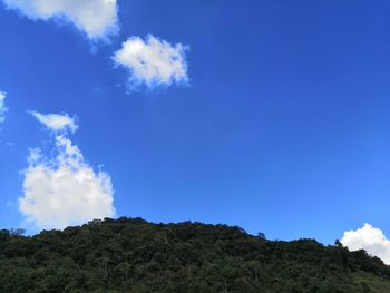 Low angle view of mountain against blue sky