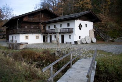 Exterior of house by building against sky