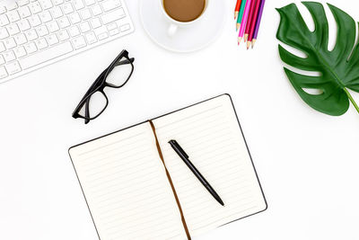 Directly above shot of eyeglasses and coffee cup on table