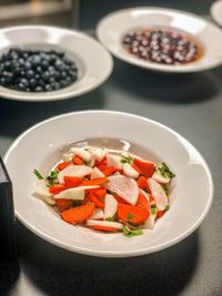 High angle view of chopped fruits in plate on table