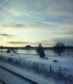 Scenic view of frozen lake against sky during sunset