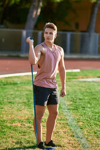 Portrait of teenage girl standing on field