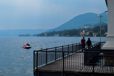 Lake by mountains against sky