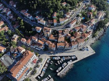 High angle view of crowd by swimming pool against buildings in city