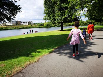 Family walking on footpath in city