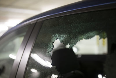 Reflection of man in car window