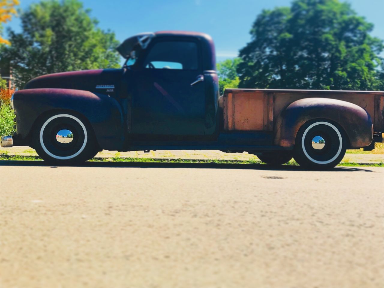 CLOSE-UP OF CAR ON ROAD