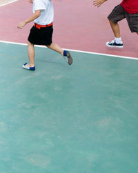 Low section of people playing with ball