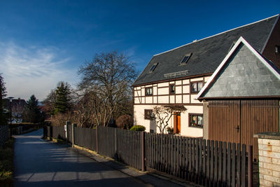 Footpath by building against sky