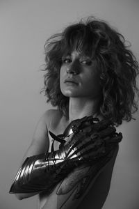 Close up pretty naked woman with knight glove in studio monochrome portrait picture