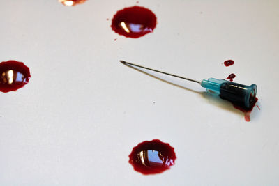 High angle view of thumbtacks on table