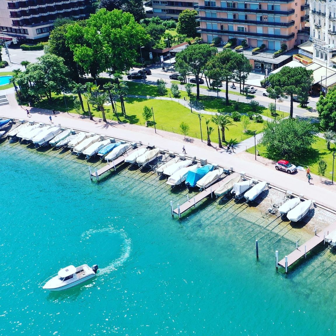 water, marina, high angle view, architecture, building exterior, transportation, built structure, mode of transportation, nautical vessel, dock, nature, day, city, tree, swimming pool, waterfront, sea, plant, no people, building, outdoors, travel destinations, moored, vehicle, travel, resort, aerial photography, residential district, luxury, sunlight, vacation, beach