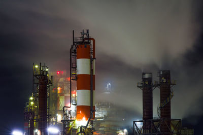 Oil refinery smoke at night