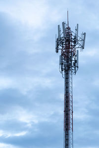 Low angle view of communications tower against sky