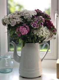 Close-up of flower vase on windowsill 