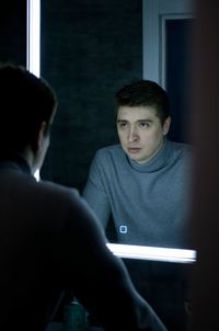 Portrait of boy looking at laptop at home