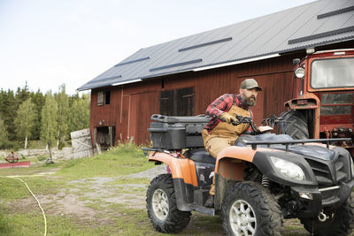 Male farmer driving four-wheeler