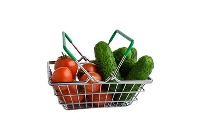 Close-up of fruits in basket against white background
