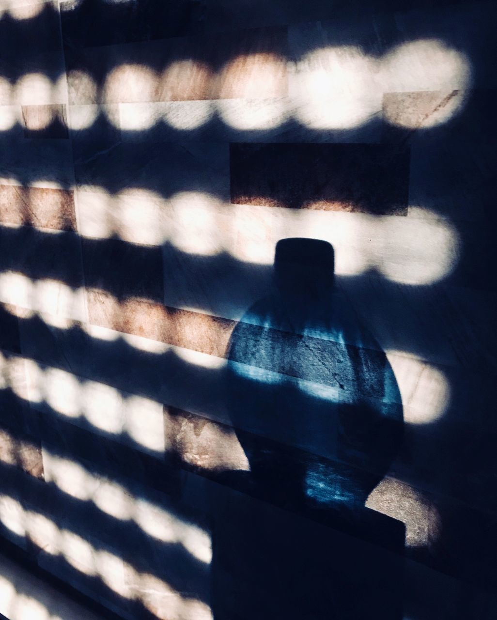 CLOSE-UP OF SUNLIGHT FALLING ON WALL