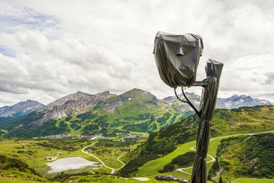 Rear view of man standing on mountain against sky