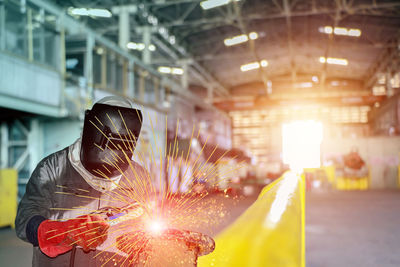 Man working at illuminated factory