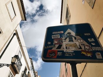 Low angle view of road sign against sky