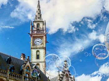 Low angle view of clock tower against sky