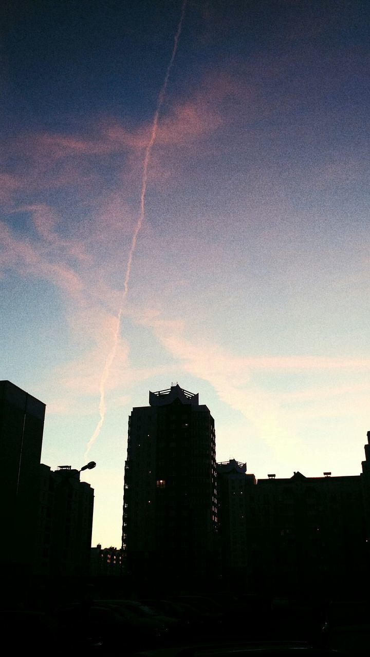 architecture, building exterior, built structure, silhouette, city, urban skyline, low angle view, sky, skyscraper, tall - high, vapor trail, dark, building story, outdoors, city life, outline, office building, downtown district, cloud - sky, financial district, scenics, no people, majestic, high section