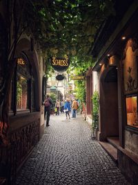 People on street amidst buildings in city
