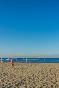 Scenic view of beach against clear blue sky